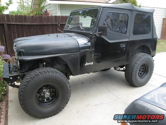 Black Jeep CJ7 with a soft top, off-road tires, and aftermarket bumper