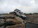 1991 Ford Bronco - Silver Hummer H3 navigates a rocky obstacle course during an off-road event.
