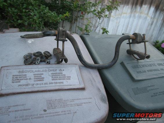 Metal part with rubber grommets and bolts on recycling bins