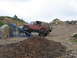 1991 Ford Bronco - A red Jeep Wrangler navigates an obstacle during an off-road event.