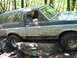 1991 Ford Bronco - This Ford Bronco is navigating a rocky trail in a wooded area.