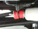 1978 Ford Bronco - Close-up view of red suspension bushings and a white shock absorber, likely part of a vehicle's undercarriage.