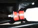 1978 Ford Bronco - Red polyurethane bushings are installed on a vehicle's shock absorber assembly.