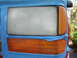 1992 Ford Explorer - Close-up of a vehicle's headlight and turn signal assembly being prepped for painting.