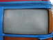 1992 Ford Explorer - Close-up of a vehicle's headlight assembly, partially covered with blue painter's tape.