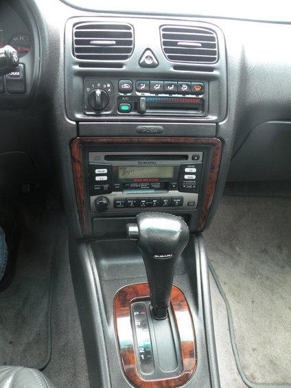 1998 Subaru Legacy interior showing automatic gear shifter and center console with radio and climate controls