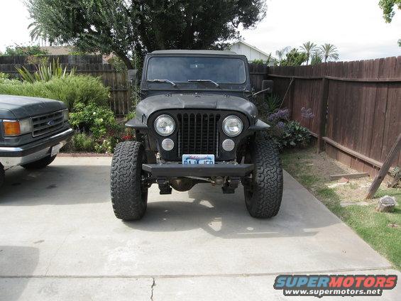 Black Jeep CJ parked next to a dark gray Ford truck