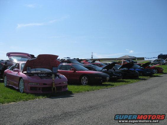 Pink car with hood and trunk open, trophy on display