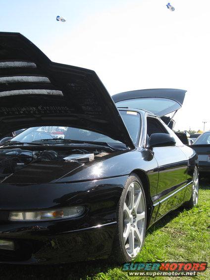 Black 1994 Ford Probe with hood and trunk open, front 3/4 view