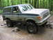 1991 Ford Bronco - 1991 Ford Bronco navigating a rocky stream during an off-road event.