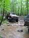 1991 Ford Bronco - An off-road truck navigates a challenging rocky stream during a spring ride event.