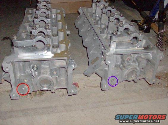 Two engine cylinder heads are shown side-by-side on a concrete floor