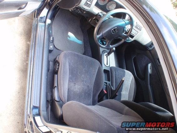 Interior view of a car with cloth seats and a Honda steering wheel