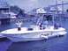 1979 Ford F-250 - A boat named 'Myster E' is docked with people on board and a child standing on the deck.
