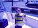 1979 Ford F-250 - A young boy enjoys a day out on the water, striking a pose on a boat with other vessels docked nearby.
