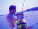 1979 Ford F-250 - A father and son enjoy a day of fishing on the water, with a small catch on the line.