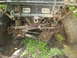 1991 Ford Bronco - Front axle and suspension of an off-road vehicle stuck in mud, showing PIAA lights.