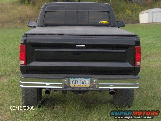 1980 Ford F-150 rear view with a black tonneau cover and chrome bumper