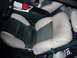 1995 Ford Thunderbird - The interior of a 1995 Ford Thunderbird shows two-tone seats and a center console with a cup holder.