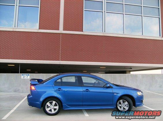 Blue 2009 Mitsubishi Lancer parked in a garage, side view