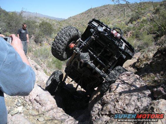 Off-road vehicle stuck on rocks, viewed from below