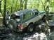 1988 Ford Bronco - A Ford Bronco navigates a rocky obstacle course in a forest setting.