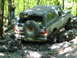 1988 Ford Bronco - A Ford Bronco navigates a rocky trail in a wooded area.