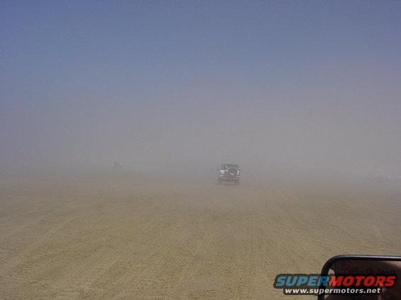 1995 Jeep Wrangler driving in a dust storm, rear view
