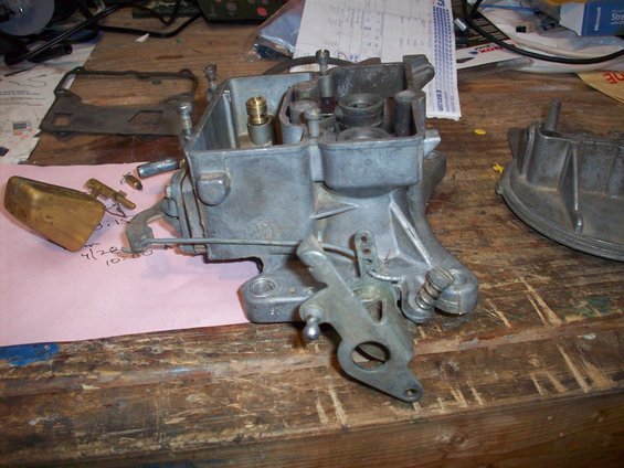 Carburetor with wooden float and linkage on workbench