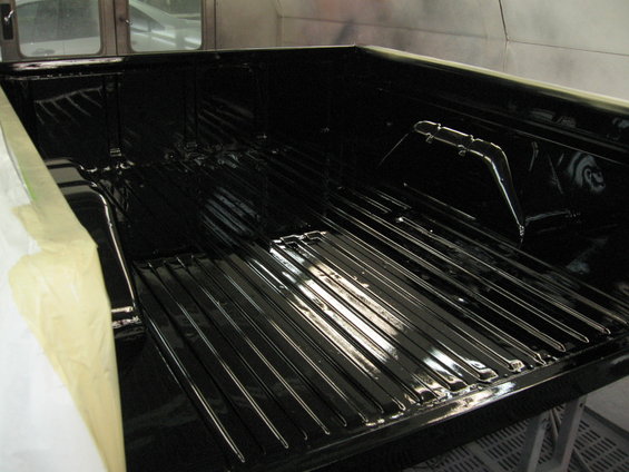 Black painted truck bed with ribbed floor, taped edges, and visible interior structure