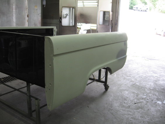 Light green 1966 Ford F-100 truck bed side panel on stand