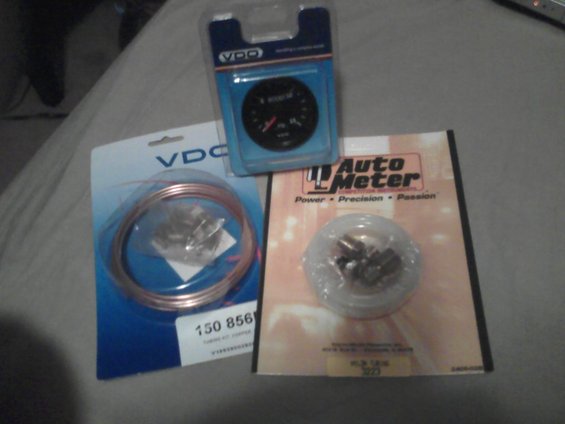 boostgaugeandtubes.jpg Olds pic I found on my cell

This is the VDO boost gauge and the tubing kits. Wasn't sure if I wanted to use copper or nylon so I bought both - ended up not using either and instead substituted rubber vac line

No room for fittings behind the boost gauge on the a-pillar, a 3/8" section of hose with a spring clamp seals to the 1/8" NPT threads wrapped with a little teflon tape. The vac line slips inside the 3/8" hose with a small section of the nylon inside it so it can't collapse from the spring clamp securing it.
