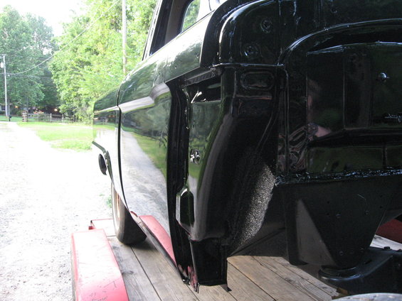 Black 1966 Ford F-100 side view, showing bed and door