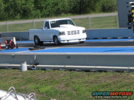 White 1994 Ford F-150 pickup truck with hood scoop on drag strip