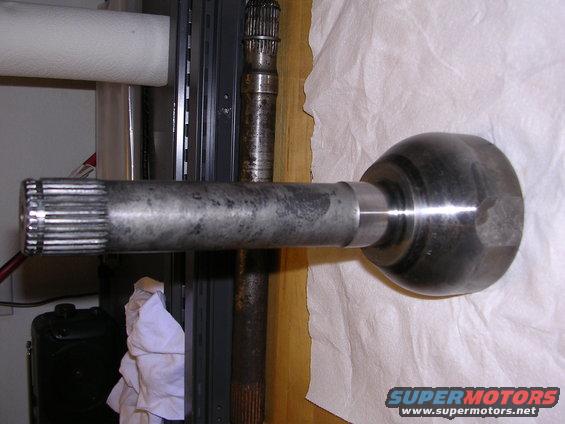 CV axle shaft with splines on one end and a ball joint housing on the other