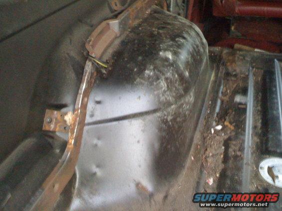 Interior wheel well and floor of a vehicle with rust and debris