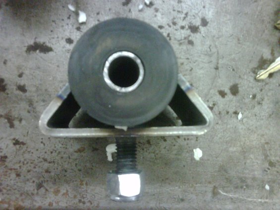 Close-up of a rubber motor mount with a metal bracket and bolt