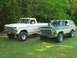 1979 Ford Bronco - Two vintage Ford trucks, a pickup and a Bronco, are parked side-by-side on a grassy area.