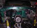 1979 Ford Bronco - The front of a green 1979 Ford Bronco is shown with its engine and transmission disassembled.