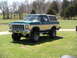 1979 Ford Bronco - Lifted 1979 Ford Bronco in two-tone green and tan, with large off-road tires.