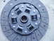 1993 Ford Probe - A close-up view of a vehicle clutch disc, showing its friction material and center spline.