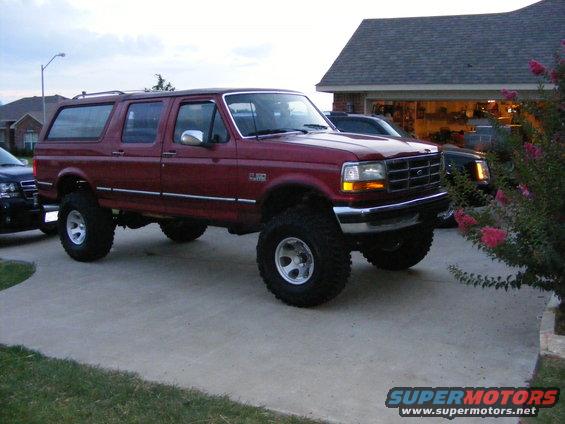 Lifted red Ford Bronco SUV parked in a driveway