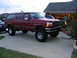 1993 Ford C-150 (Centurion Conversions) - This lifted red SUV has a grille consistent with a 1992 model year Ford.