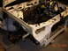 1995 Ford Taurus - Front end of a 1995 Ford Taurus disassembled, revealing the engine bay and chassis components.
