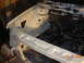 1995 Ford Taurus - The engine bay of a vehicle is shown, painted white, with the frame and wiring exposed.