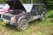 2004 Arctic Cat F-7 Firecat - A black Jeep Cherokee sits in a grassy area with its hood open, revealing the engine. Text on the rear window indicates a price and phone n…