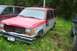 2004 Arctic Cat F-7 Firecat - Damaged 1991 Ford Explorer parked in grass next to another vehicle.