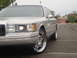 1992 Lincoln Town Car - A silver Lincoln Town Car is shown from the front passenger side, chrome wheels and a cloudy sky.