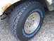 1988 Ford Bronco - Close-up of a Sumitomo All-Terrain tire and wheel assembly on a vehicle.