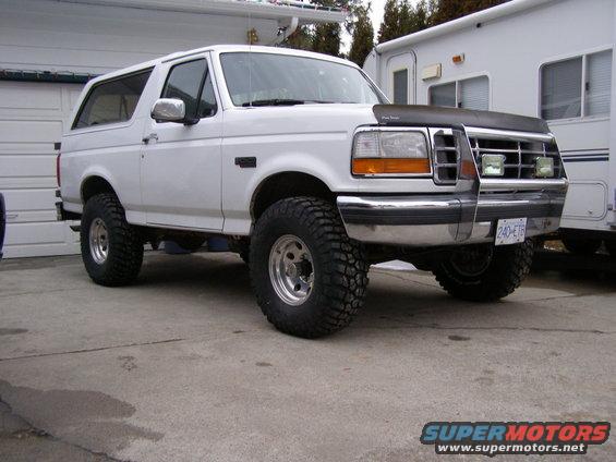 1993 Ford Bronco with lifted suspension parked in driveway